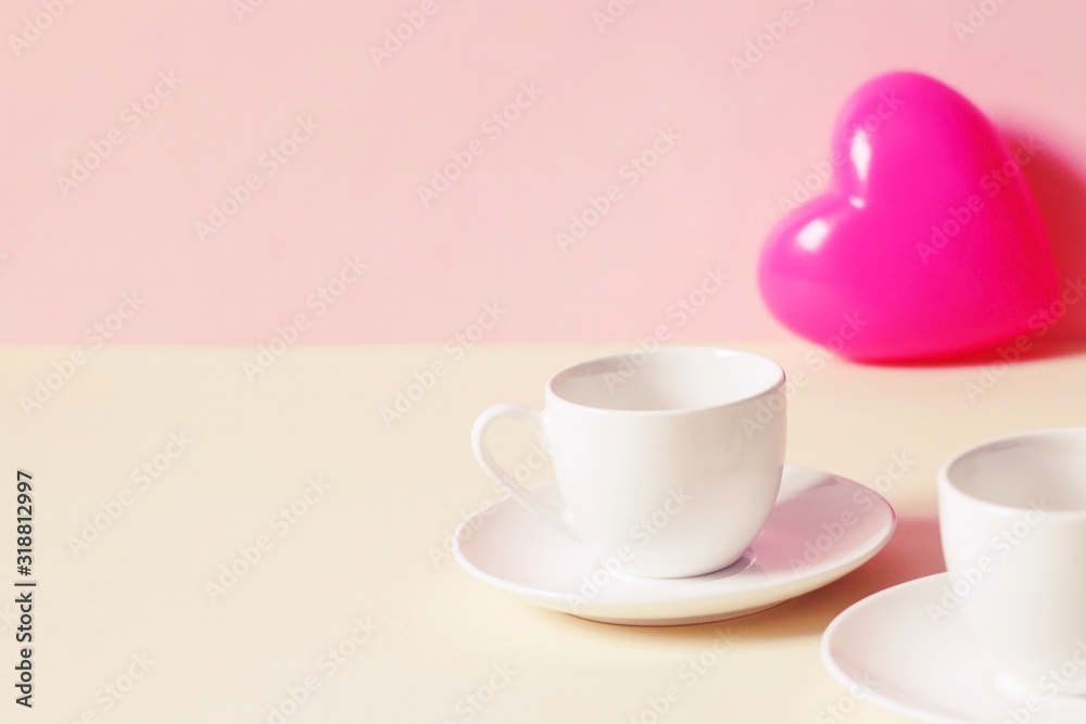 Two small cups of coffee and a pink heart. Photo for Valentine's Day Two small cups of coffee and a pink heart. Photo for Valentine's Day
