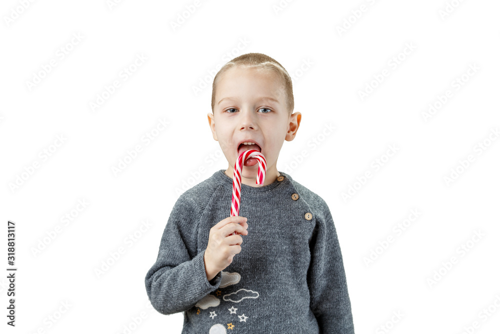 Little european boy eating a lollipop. Studio photography on an isolated white background. Little european boy eating a lollipop. Studio photography on an isolated white background.