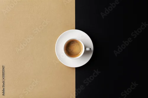 Obraz Cup of coffee on gold black background. Minimalistic flat lay. Top view.
