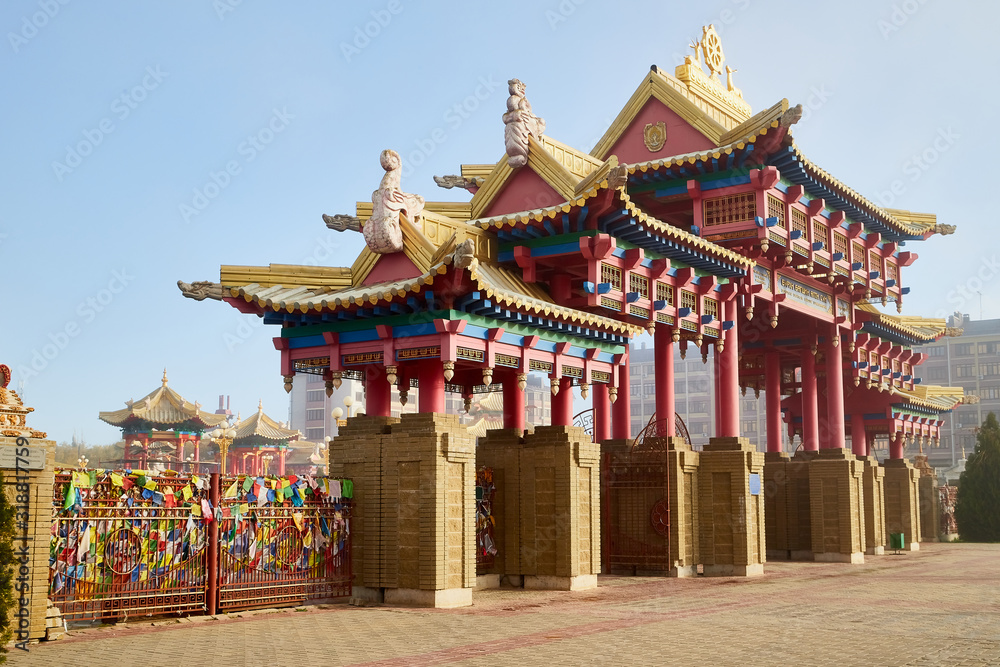 Naklejka premium Entrance in buddhist temple in the fog on a summer, spring or autumn day. Buddhism in Russia in Elista
