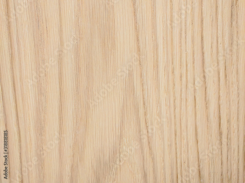 Light beige wooden background made of natural tree material with pattern of lines on a block panel used to cover interior and exterior surface