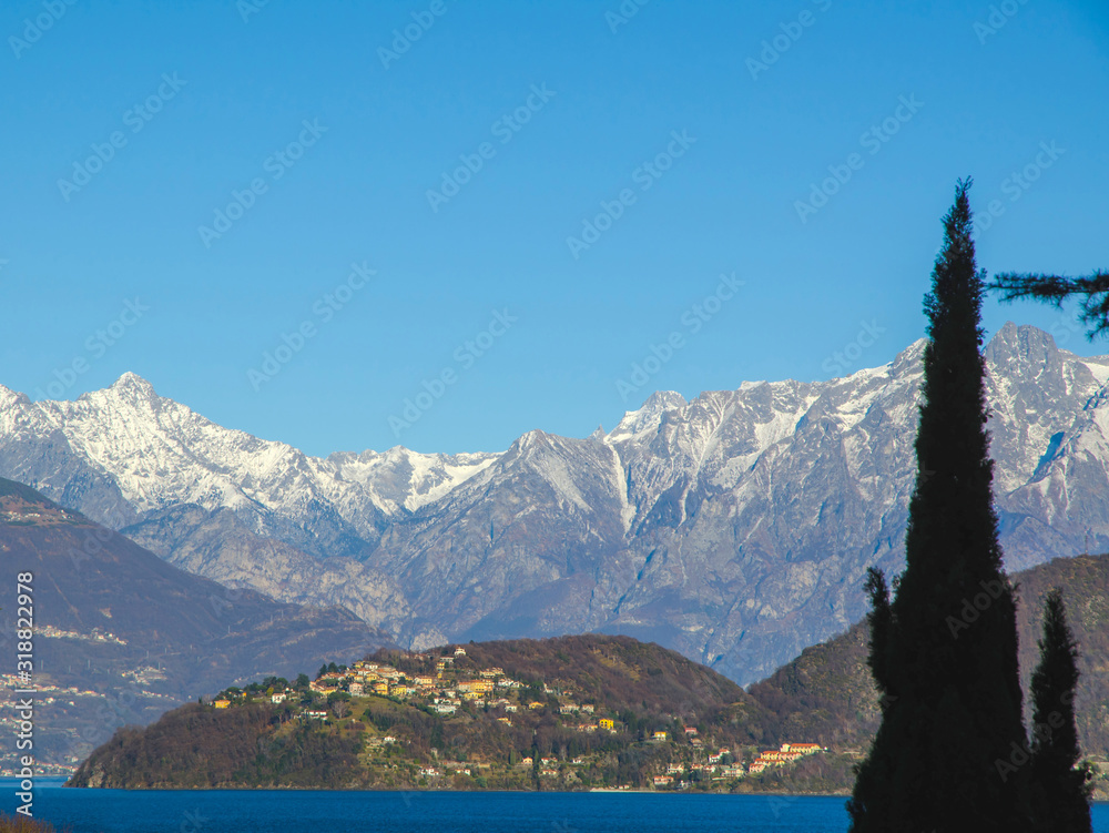 Village on Lake Como with Snow-capped Mountain in Lombardy, Italy.