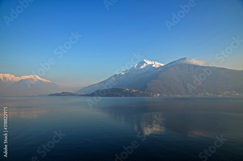 Village on Lake Como with Snow-capped Mountain in Lombardy, Italy.