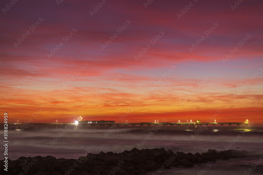 Nice colorful clouds after sunset at a pier over the Pacific Ocean. Ocean Beach neighborhood of San Diego, California.