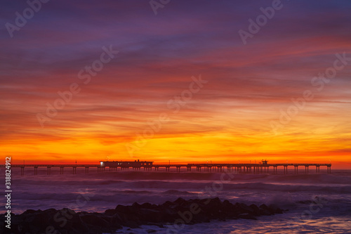 Nice colorful clouds after sunset at a pier over the Pacific Ocean. Ocean Beach neighborhood of San Diego, California.