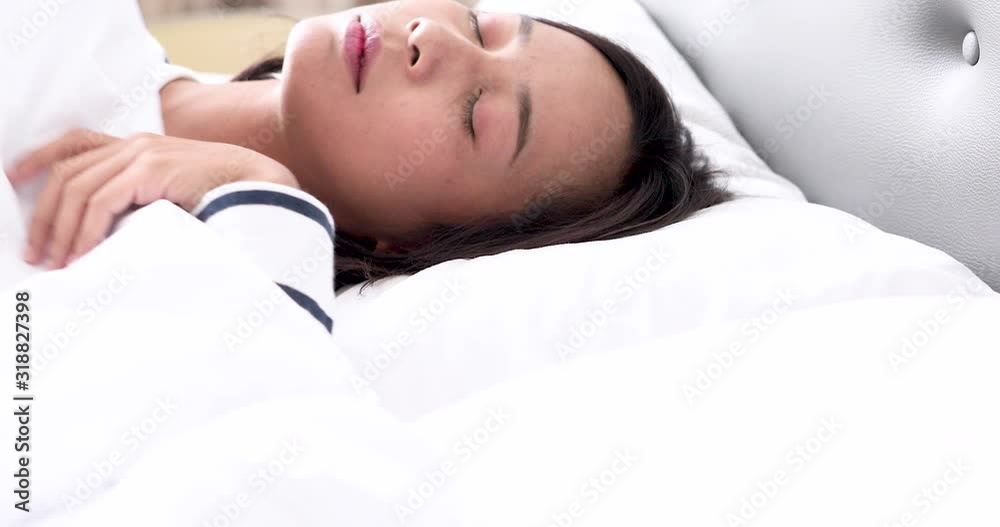 face of young Caucasian woman lying and stretching on bed after waking up early in the morning face of young Caucasian woman lying and stretching on bed after waking up early in the morning