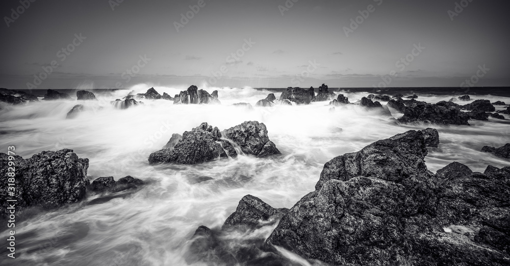 Obraz premium Porto Moniz - Long exposure of rocks and waves at vulcanic coast - beautiful landscape scenery of Madeira Island, Portugal