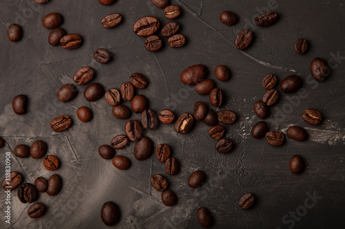 Composition with a coffee beans on a textured plastered background with a variety of arbitrary stains