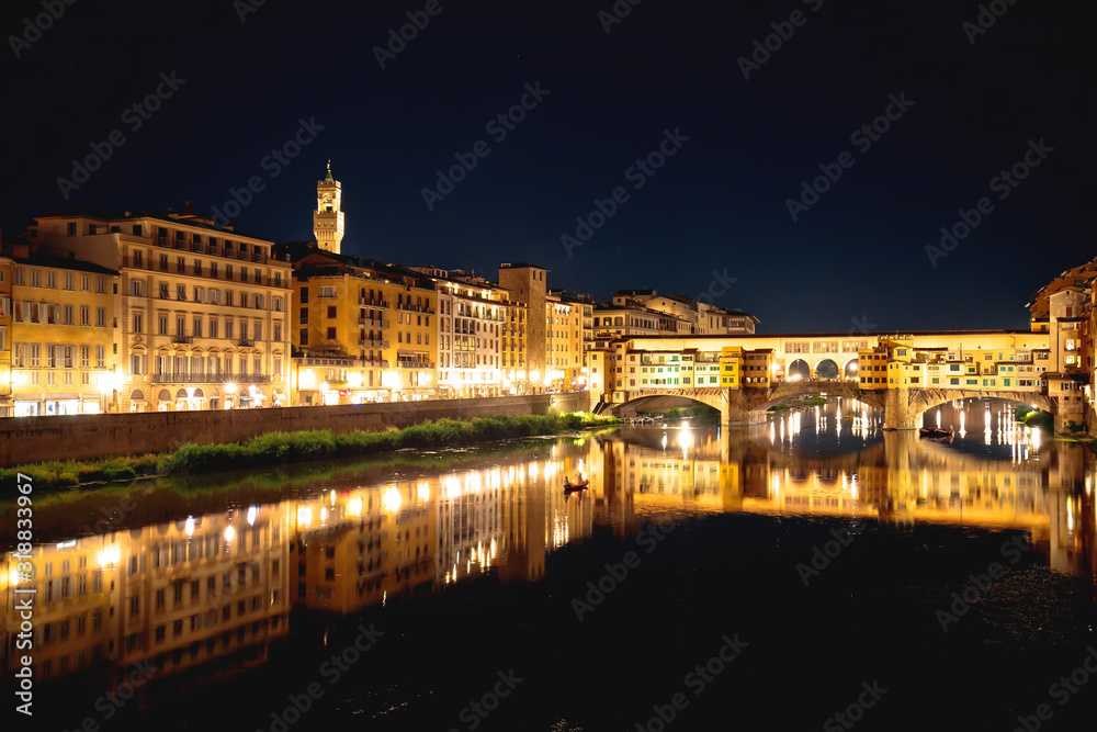 Ponte Vecchio bridge and Arno river waterfront in Florence evening view