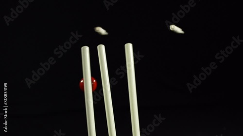 Cricket Wickets bowled out - The stumps are hit with the ball. Black background. Super Slow Motion