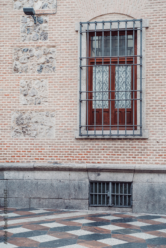 Interesting door, wall facade and tile street in Madrid Spain