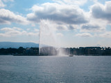 Jet d’Eau fountain, houses and mountains in Geneva.