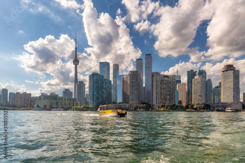 Photography Toronto city skyline and water taxi in the lake at sunset in Toronto, Ontario, C