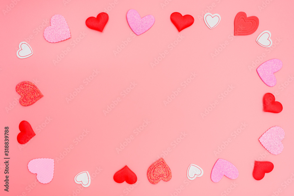 Pink background framed with red hearts for romantic motives in Valentine's Day, copy space.