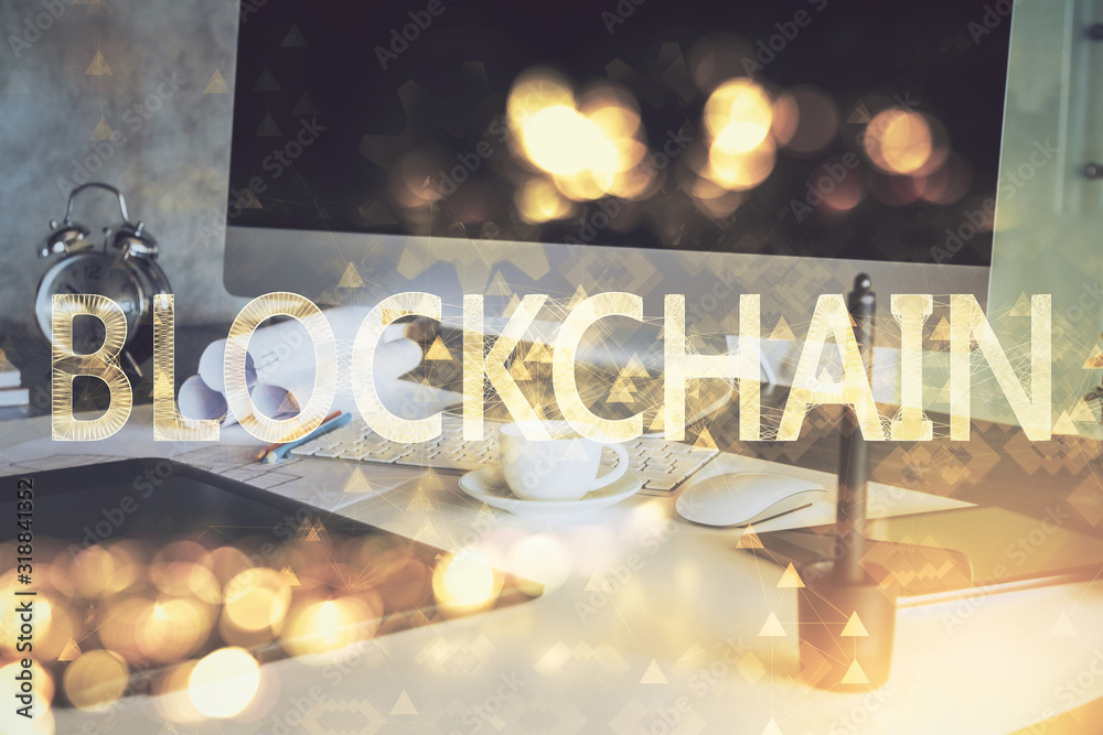 Double exposure of blockchain theme hologram and table with computer background. Concept of bitcoin crypto currency.