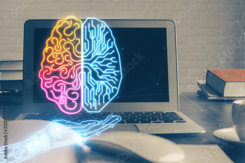 Multi exposure of work table with computer and brain hologram. Brainstorm concept.