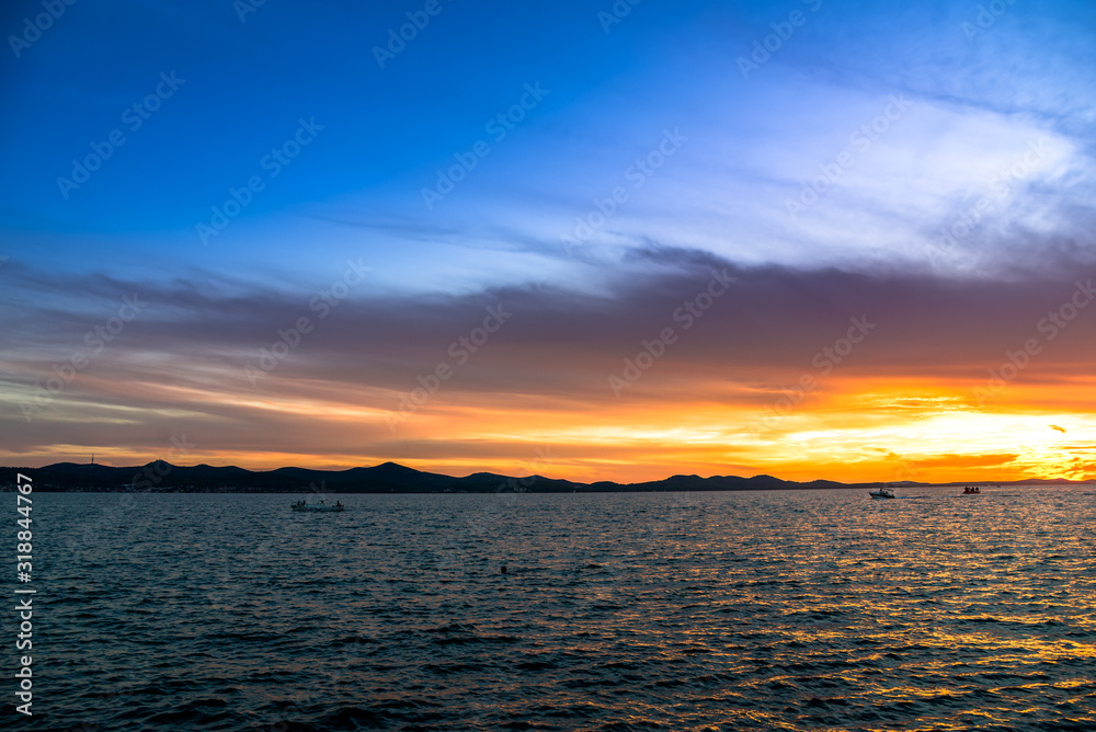 Background with landscape of sunset over sea, scenic view from beach in Zadar, Dalmatia, Croatia, Europe Background with landscape of sunset over sea, scenic view from beach in Zadar, Dalmatia, Croatia, Europe