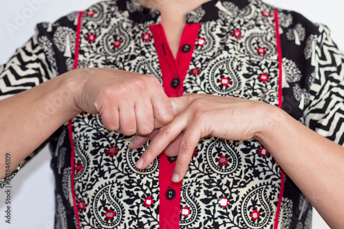 A woman practicing Jin Shin Jyutsu japanese technique for self-helping © Imagenatural