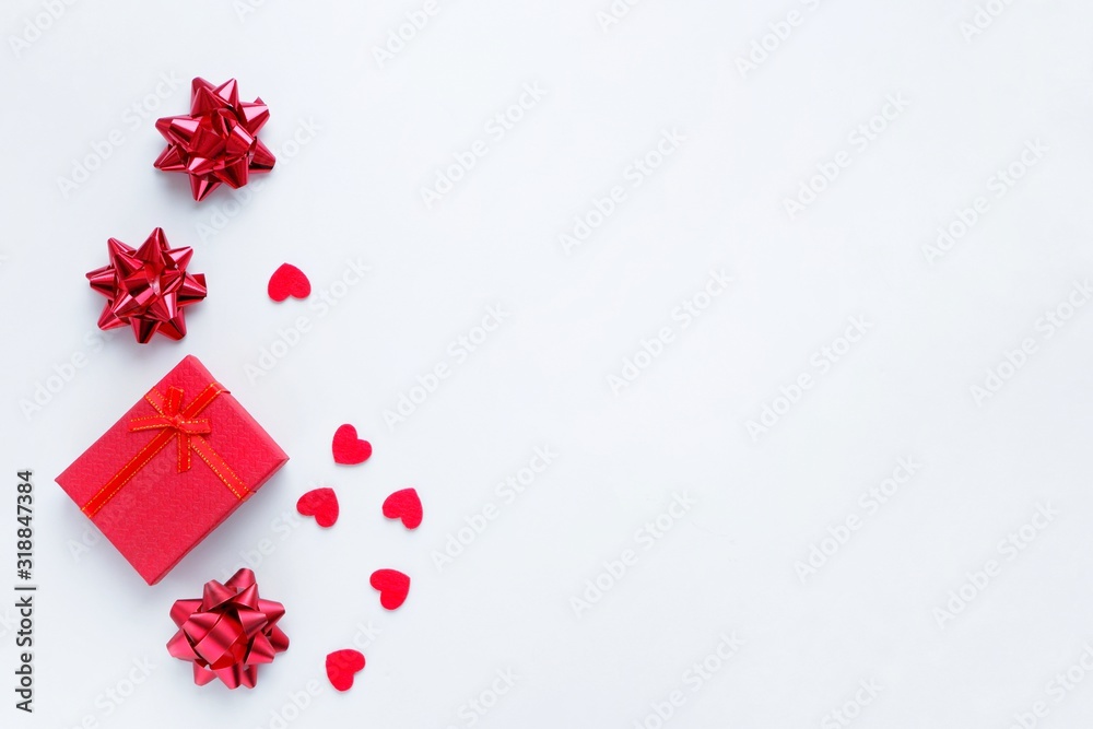 Gift box, bows and red hearts on a white background. The concept of Valentine's Day, love, romance, congratulations, holiday. Top view, flat lay, copy space for text. Gift box, bows and red hearts on a white background. The concept of Valentine's Day, love, romance, congratulations, holiday. Top view, flat lay, copy space for text.