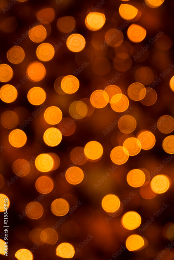 Defocused of blurred golden orange bokeh circle light from lighting bulb in the night for abstract background texture