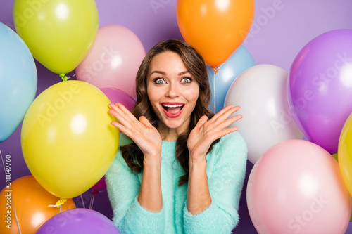 Photo of pretty lady hands raised near cheeks surrounded many colorful air balloons announcing black friday opening wear pastel fuzzy pullover isolated purple color background