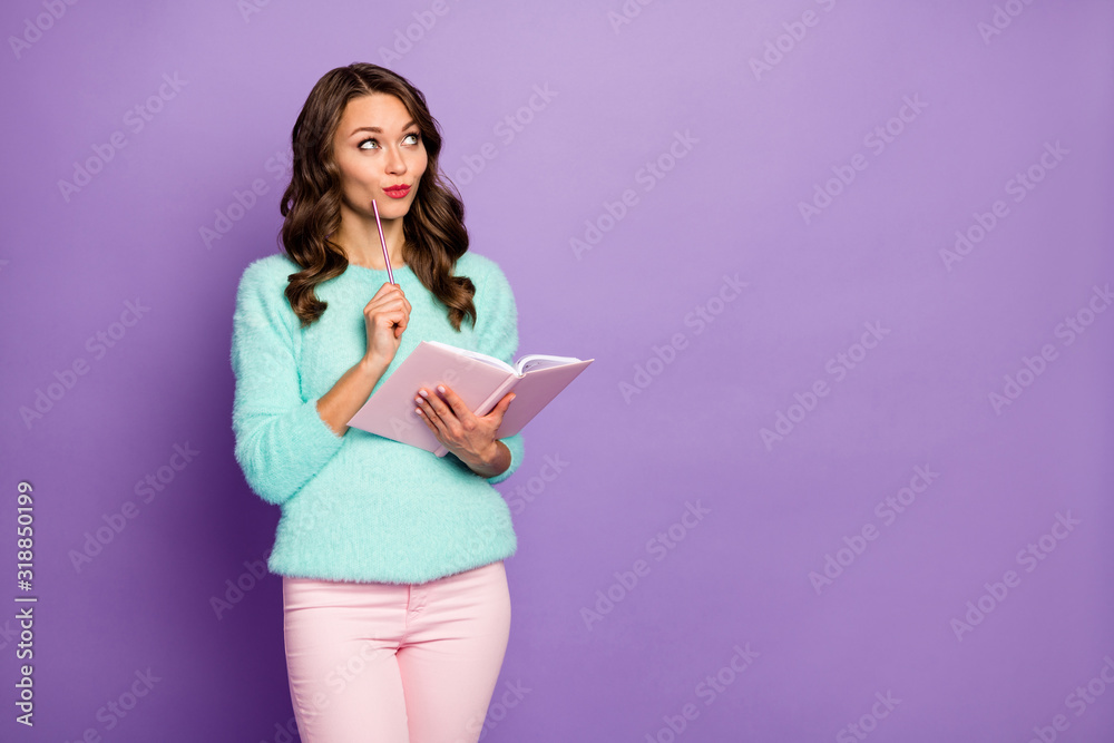 Photo of beautiful wavy lady hold planner write own novel look empty space interested waiting inspiration wear fuzzy sweater pastel pink trousers isolated purple color background Photo of beautiful wavy lady hold planner write own novel look empty space interested waiting inspiration wear fuzzy sweater pastel pink trousers isolated purple color background