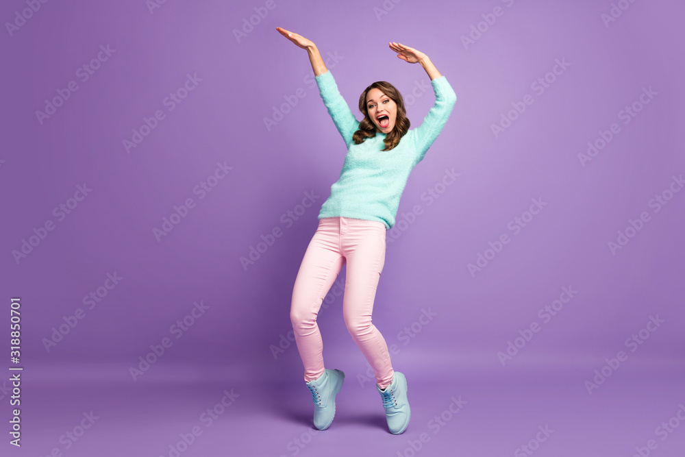 Full body photo of chilling funny lady raise hands dancing youth modern moves crazy student wear casual fluffy pullover pastel pink pants shoes isolated purple color background