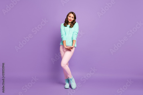 Full length photo of beautiful wavy lady flirty good mood coquettish look shy person wear teal pastel fluffy pullover pink pants blue boots isolated purple color background