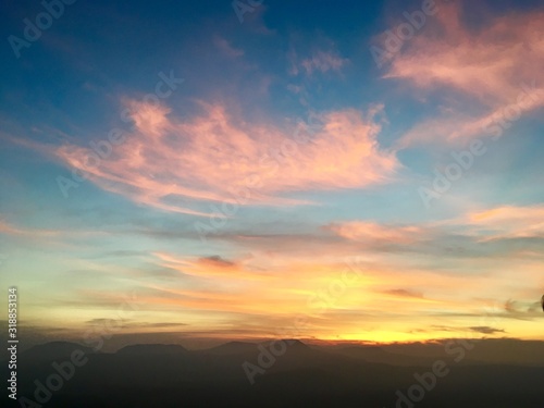 Background blue sky and orange light of sun