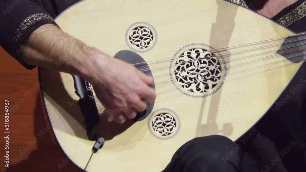 Close-up of the artist performing the oud