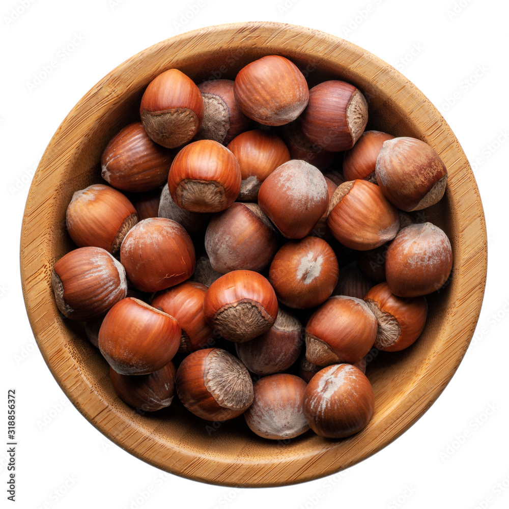 Unpeeled hazelnuts in a round wooden bowl Unpeeled hazelnuts in a round wooden bowl
