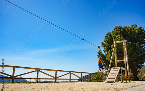Adult woman having fun on zipline