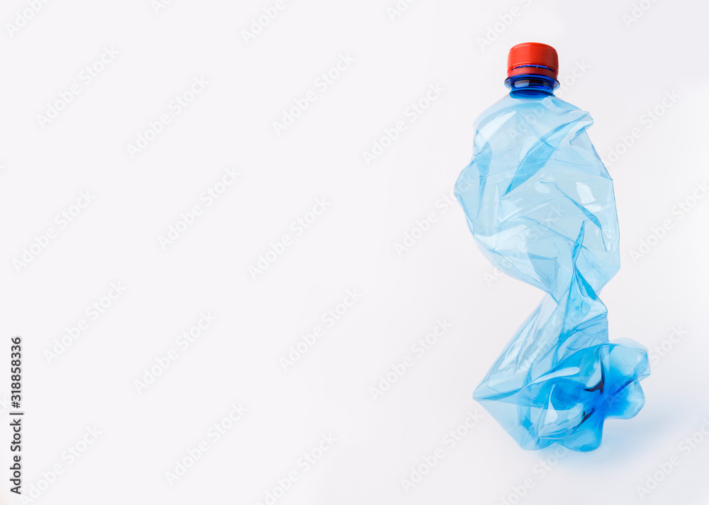 Crumpled or squashed blue plastic bottle isolated on white Crumpled or squashed blue plastic bottle isolated on white