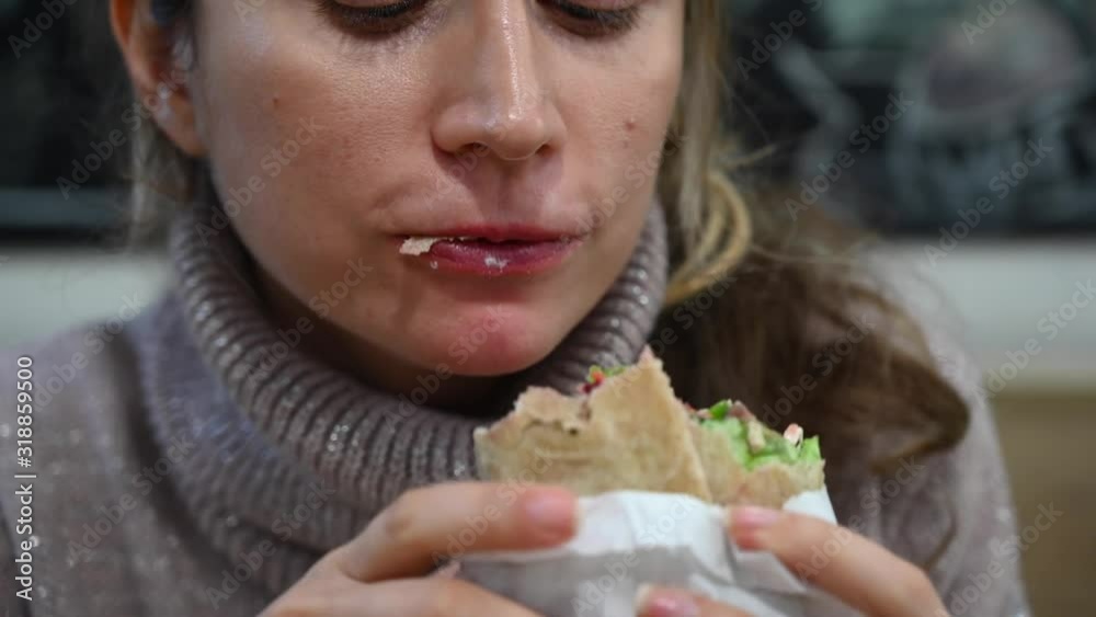 Woman eating a vegan wrap at business lunch