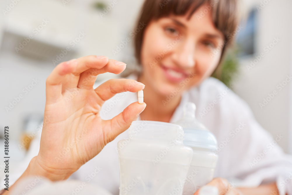 Mother with vitamin tablet and baby food Mother with vitamin tablet and baby food