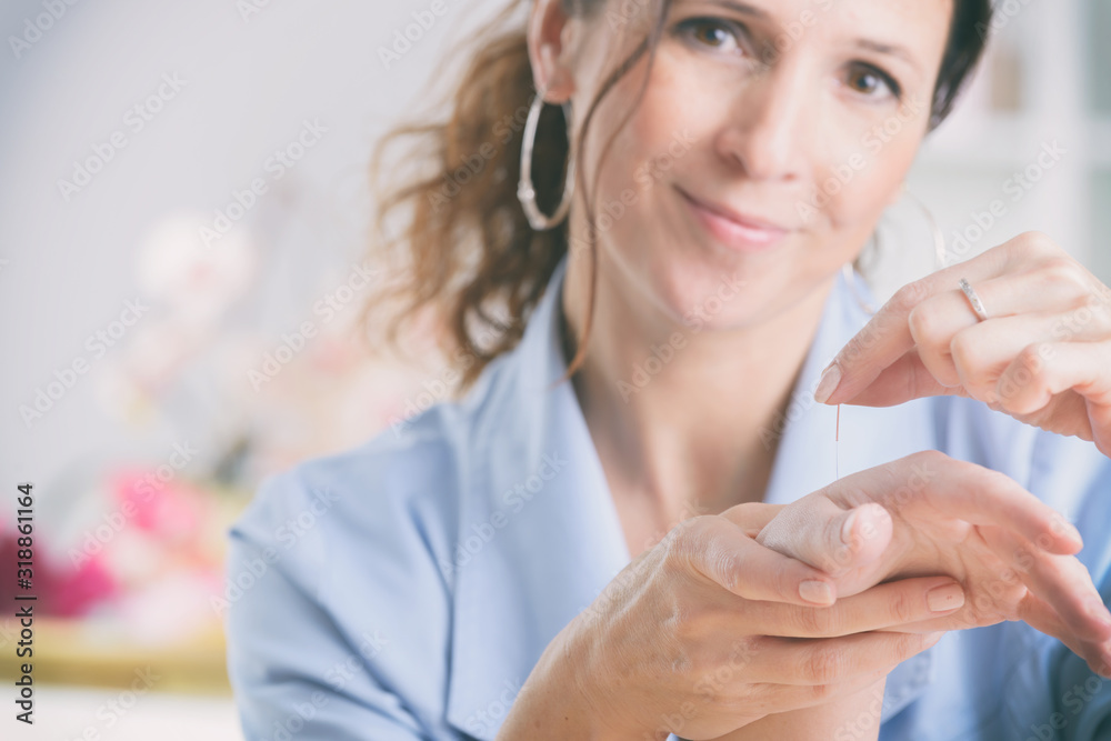 Therapist applying acupuncture needle
