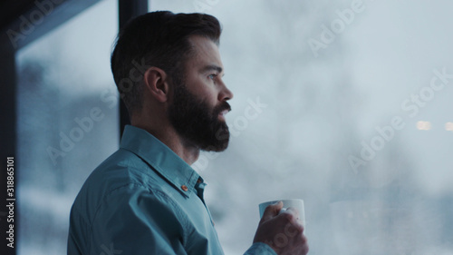Tablou pe pânză Close up handsome businessman drinking coffee and admire view standing by window