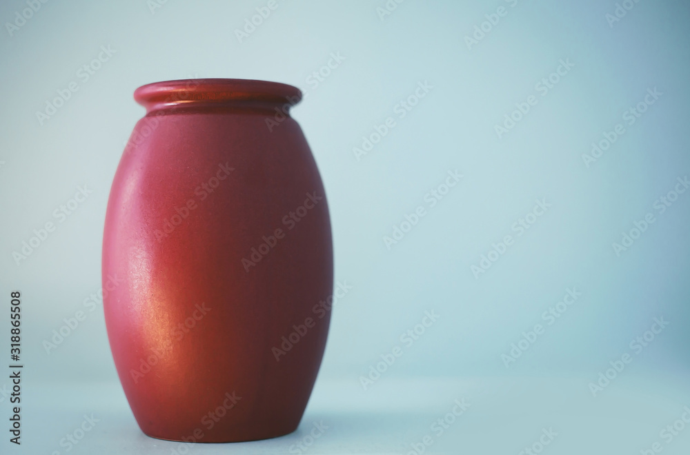 red clay vase on blue background