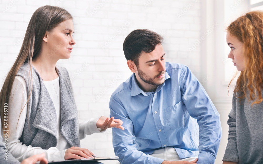 Marriage counselor consulting unhappy couple, giving advice for their relationship Marriage counselor consulting unhappy couple, giving advice for their relationship