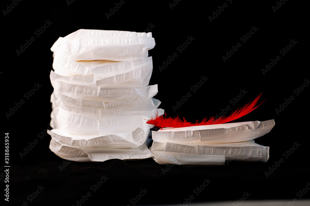 Menorrhagia heavy menstruation bleeding. Sanitary napkin pads in stack