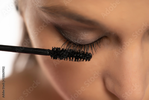 mascara applying on female natural eyelashes