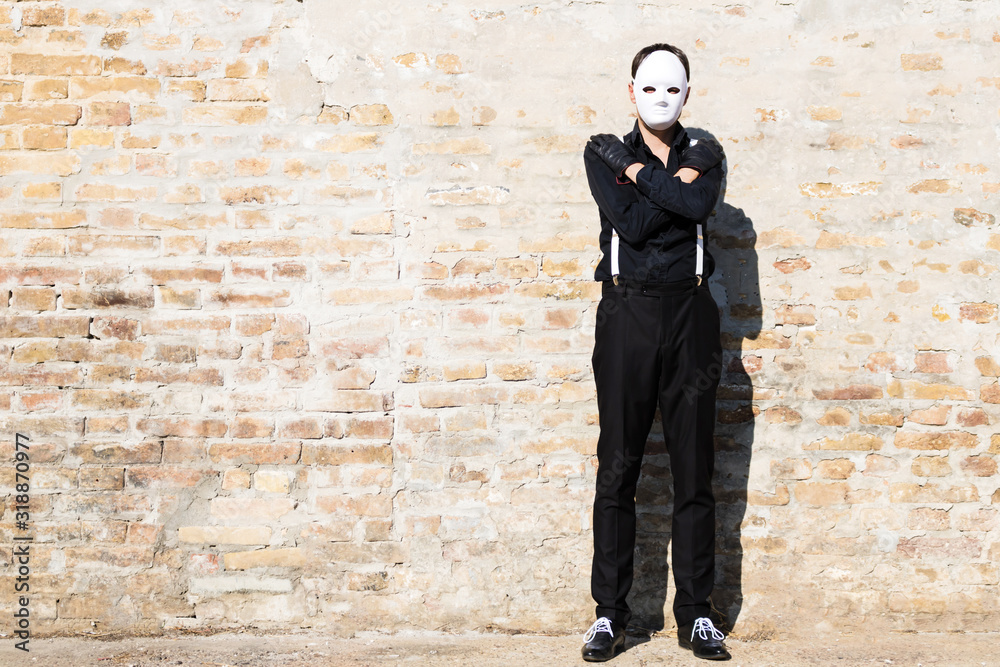 Full length of a man with mask against the wall. Full length of a man with mask against the wall.