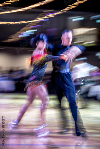 Blurred dancing couple in ballroom