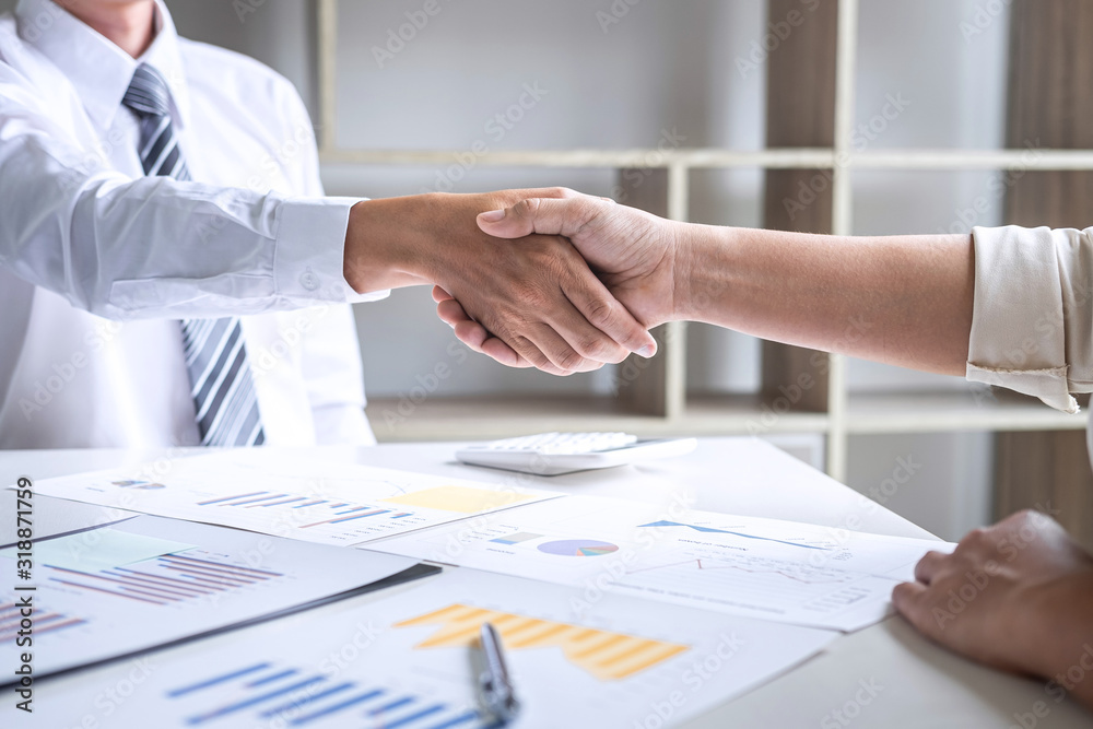 Finishing up a conversation after collaboration, handshake of two business people after success good deal contract negotiation agreement to become a partner, collaborative teamwork Finishing up a conversation after collaboration, handshake of two business people after success good deal contract negotiation agreement to become a partner, collaborative teamwork