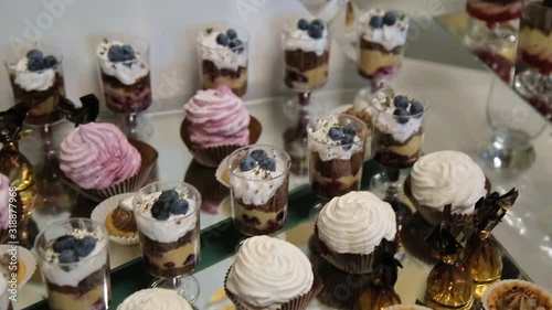 Background filled with colorful cakes and desserts with fresh fruits