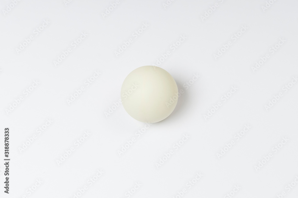 white pinpong ball on a white background top view, space for text on the left and right white pinpong ball on a white background top view, space for text on the left and right