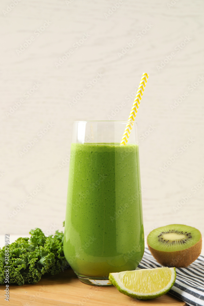 Tasty fresh kale smoothie and ingredients on table Tasty fresh kale smoothie and ingredients on table