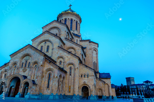 The Cathedral of the Holy Trinity or tsminda Sameba (translated as the Holy Trinity). Night photo, lights, moon over the Cathedral