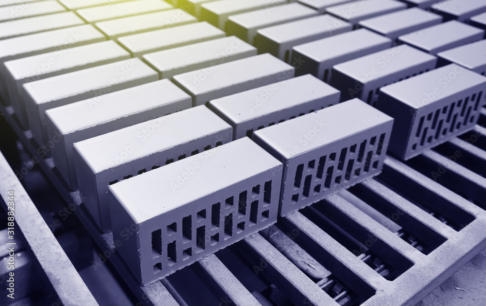 Obraz premium Brick production. New bricks on a conveyor belt at a brick factory. Text space