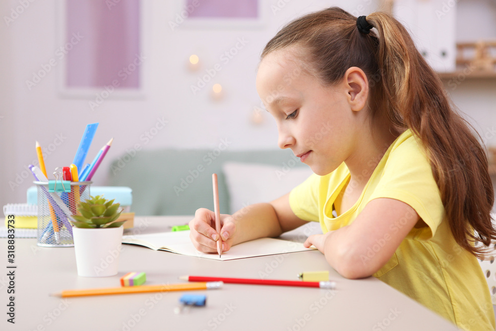 Cute little girl is doing homework in the interior of the room. Cute little girl is doing homework in the interior of the room.